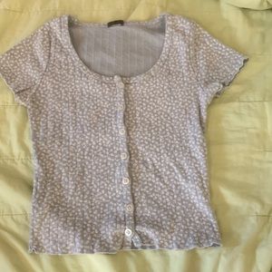 Im selling a Brandy Melville Blue with White flower tiny tee-shirt.